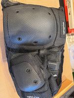 Mesh bag holding the full set of protective pads
