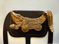 Front view of brass alligator pocket clip detailing shape and clip backing