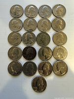 Obverse view of 21 Washington quarters