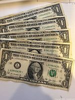Five overlapping $1 star notes showing serial numbers and star designation