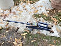 Full view of blue Guardian 2-ton floor jack on ground