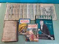 Group shot of all 15 items showing titles and covers