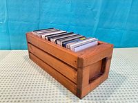 Perspective of wooden box filled with CDs