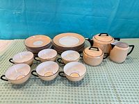 Full set laid out including plates, teapot, smaller pot, creamer, and cups