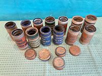Three rows of Edison Amberol and Blue Amberol tubes with cylinders inserted, five loose lids in foreground