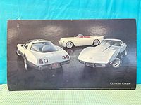Front of poster with Corvette images