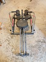 Top view of entire rowing machine showing frame, seat, arms, rails