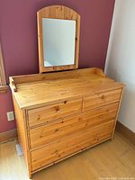 Front view of knotty pine dresser with attached mirror