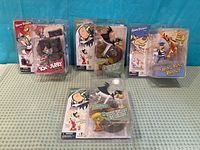 Group shot of four sealed Hanna-Barbera Series 1 action figure packs