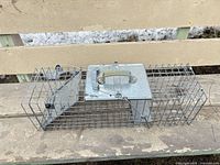 Full view of Havahart live trap showing cage, door and handle