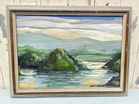 front view of framed river landscape painting