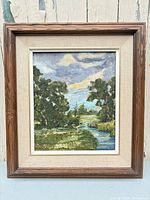 Front view of framed oil landscape painting