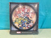 Front view of sealed Marvel Avengers wall clock in packaging