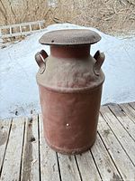 Full view of milk can front showing lid and handles