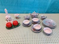 Full lot showing tea set pieces, tomato shakers on tray, floral bell and small cup