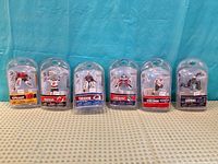 Six blister-packed NHL mini figures lined up