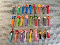 Full group view of 29 PEZ dispensers laid out in three rows