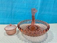 Bowl with figurine insert assembled beside lidded candy dish
