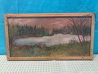 Front view of framed pond landscape painting