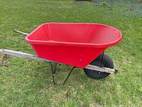 Side view showing red plastic tub, wood handles, single wheel