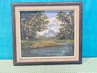 Front view of framed oil painting showing river scene