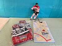 Figure with base alongside two sealed hats