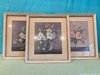 All three framed floral prints displayed