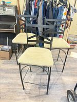 Front view of three matching metal barstools