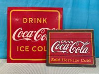 Both Coca-Cola signs front view displaying graphics and scale contrast