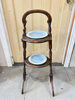 Front view showing stand holding two blue Wedgwood plates