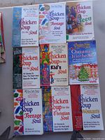 Ten assorted Chicken Soup for the Soul books laid out on table