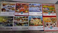 Eight boxed Charles Wysocki 1000-piece puzzles, assorted scenes