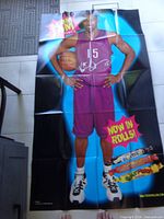Large folded poster of basketball player in purple Toronto uniform with text