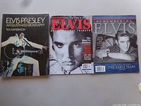 Front covers of three larger format items: Illustrated Biography, 60th Birthday Tribute magazine, Remembering Elvis magazine