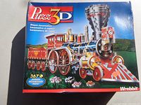 Front of Wrebbit Puzz 3D Steam Locomotive puzzle box showing artwork and specs