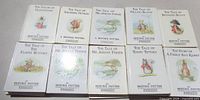 First group of ten uniform Beatrix Potter hardcovers laid flat showing titles and cover art