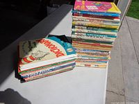 Two stacks of Dr. Seuss hardcover books, approx. 50 total