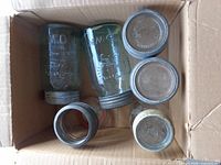 Six Crown jars in box showing lids and tint variety