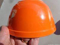 Side view of orange Pyrex bowl