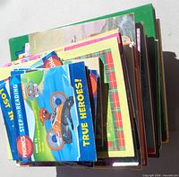 Stack of multiple children’s books topped by Paw Patrol readers