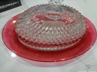 Butter dish assembled showing clear diamond-pattern lid on red underplate