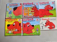 Six Clifford books laid out on tabletop