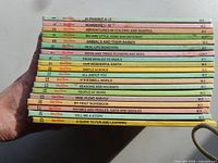 Stacked view of volumes 1-18 showing numbered spines and titles