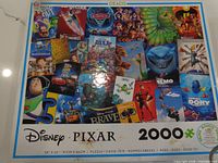 Front of puzzle box showing Pixar collage, piece count, dimensions and bonus poster note