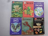 Six Golden Guide books Flowers, Trees, Orchids, Bats, Seashores, Rocks and Minerals displayed front covers
