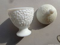 pedestal milk glass bowl and matching lid with floral relief pattern