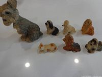 Group showing large Schnauzer and six smaller animal figurines