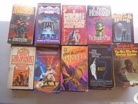 Ten paperback novels including Sherlock Holmes, Darksword, Moreta