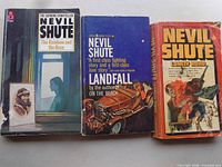 Front covers of three Nevil Shute paperbacks showing titles and cover wear