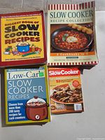 Cover view of four slow-cooker cookbooks and magazine